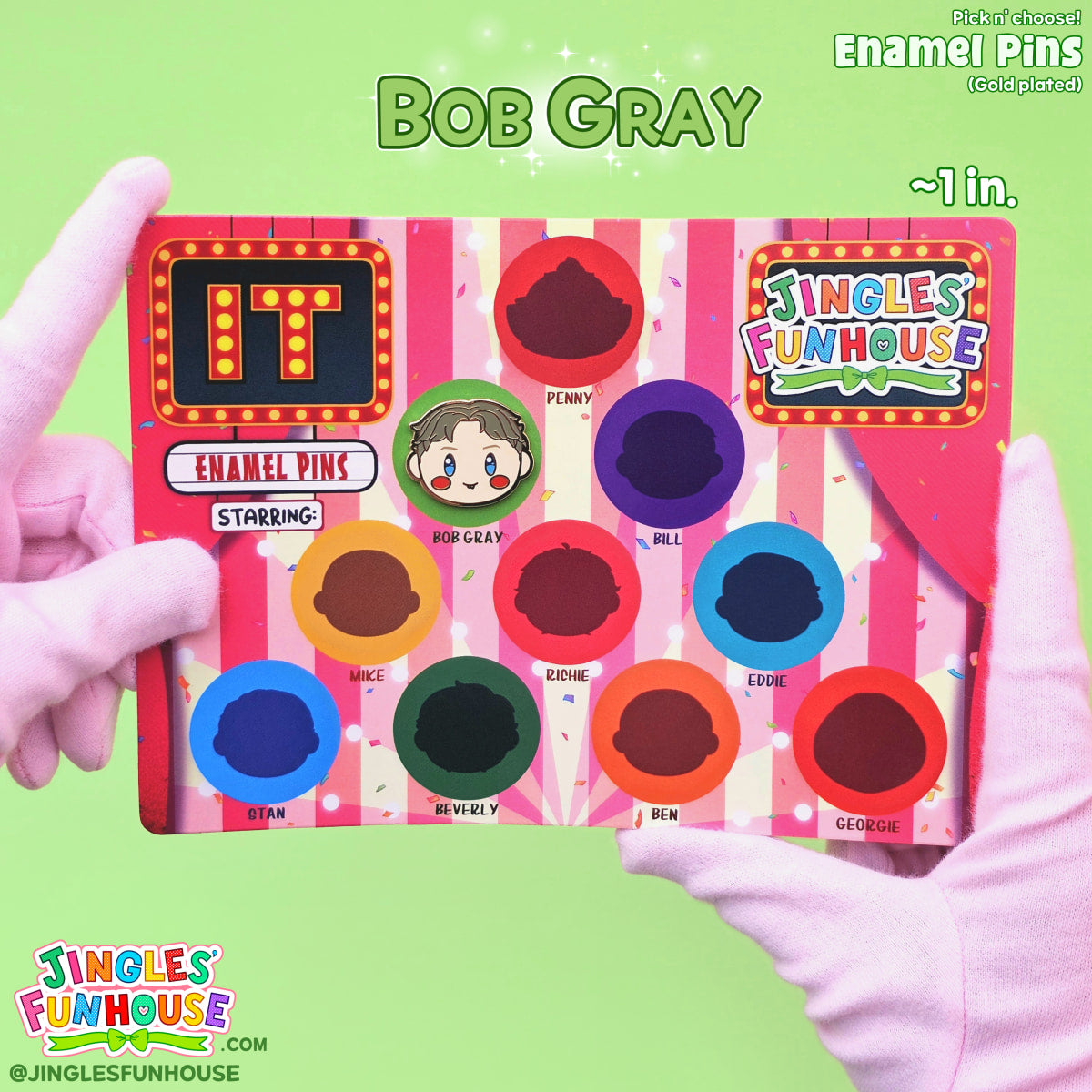 A hard enamel pin of Bob Gray (from the movie "IT") attached onto a colorful backing card. 

The size of the pin is approximately 1 inch. 

Made by Jingles' Funhouse.