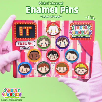 Hard enamel pins in the shape of the characters' head from the movie "IT." The characters include: The Losers' Club, Pennywise, Bob Gray, and Georgie. 

The pins are attached onto a colorful backing card. Each character has a different-colored, rubber heart-shaped pin-back; the back of the backing card showcases the pin-backs. 

The size of the pins is approximately 1 inch. 

Made by Jingles' Funhouse.