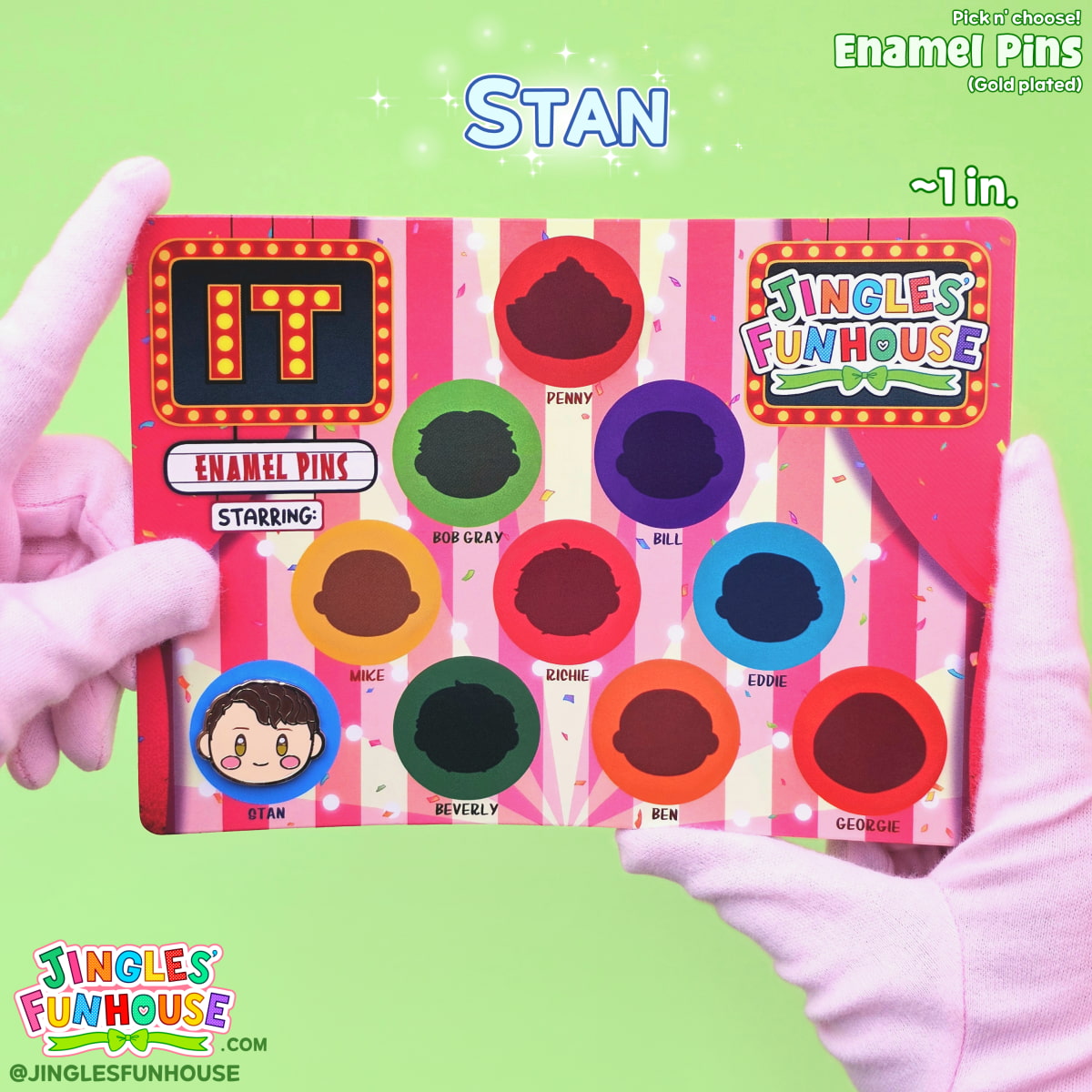 A hard enamel pin of Stan Uris (from the movie "IT") attached onto a colorful backing card. 

The size of the pin is approximately 1 inch. 

Made by Jingles' Funhouse.